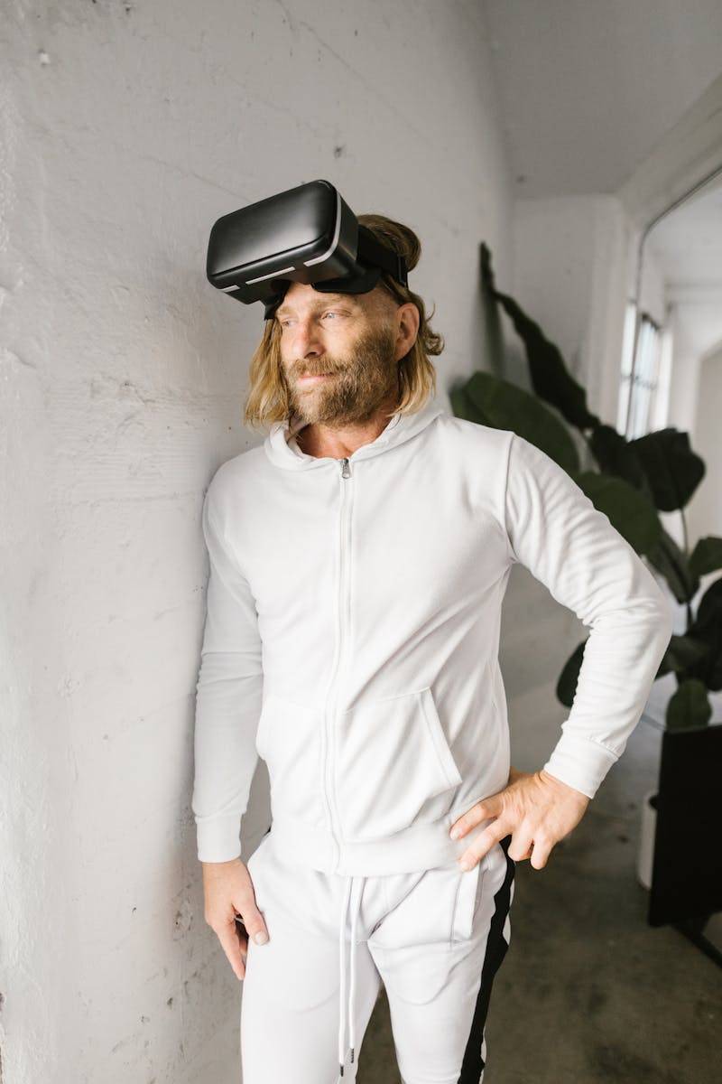 Man wearing VR headset standing indoors, engaged in virtual reality experience.